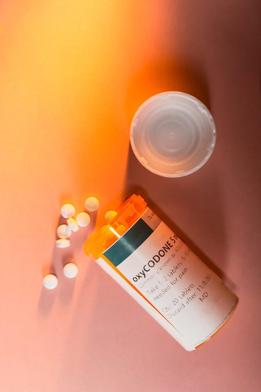 Oxycodone Prescription Bottle with Pills Spilling Out