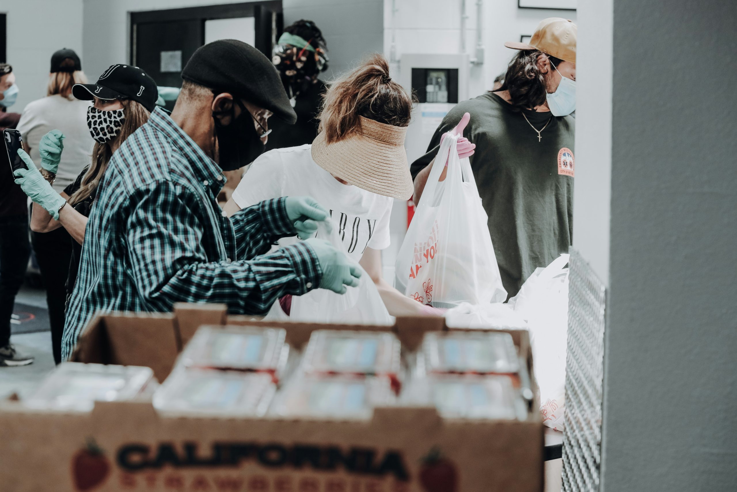 Two people exchanging a bag of food at a food bank